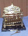 The Congreve clock was invented by Sir William Congreve in the 19th Century. Timekeeping is controlled by the time it takes a steel ball to roll down a track and release the mechanism. Although Congreve intended it as a serious precision clock, they are generally poor timekeepers, but popular because of their visual appeal. 
